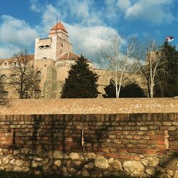 Low angle view of building against cloudy sky