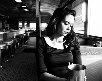 Young woman sitting on table