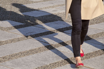 Low section of woman standing on tiled floor