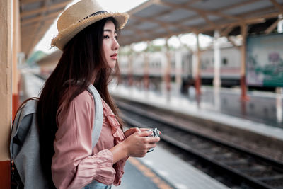 Woman looking away on railroad station platform