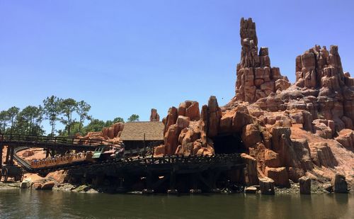 View of big thunder mountain railroad against river 