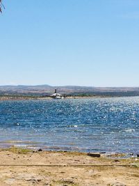 Scenic view of sea against clear blue sky