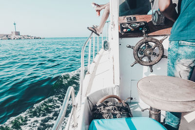 Low section of people on boat sailing in sea