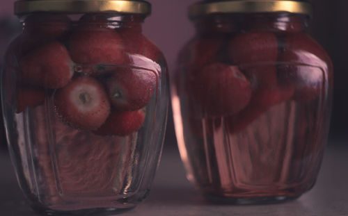 Close-up of fruits in glass jar on table