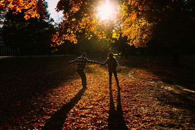 Friends standing in park during autumn