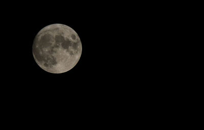 Low angle view of moon against sky at night