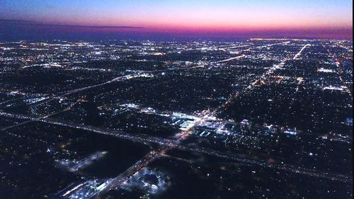 Aerial view of city lit up at night