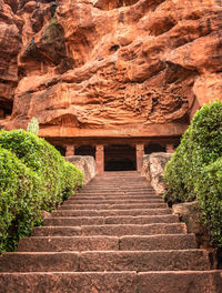 Low angle view of steps leading towards rock formation