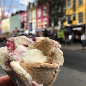 Close-up of hand holding ice cream in city