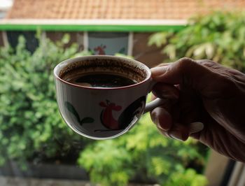 Drinking coffee by the window