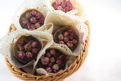 High angle view of pink roses in basket