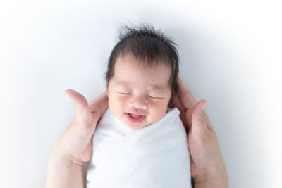 Portrait of cute baby girl over white background
