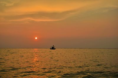 Scenic view of sea against orange sky