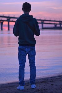 Rear view of man standing on beach