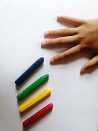 High angle view of colored pencils on white background