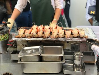 Midsection of chef preparing food in commercial kitchen