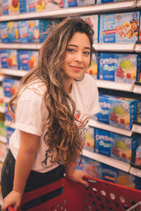 Portrait of smiling young woman standing in store