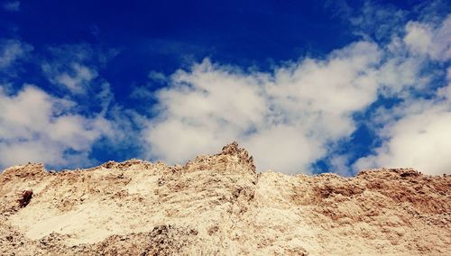 Low angle view of rock formations against sky