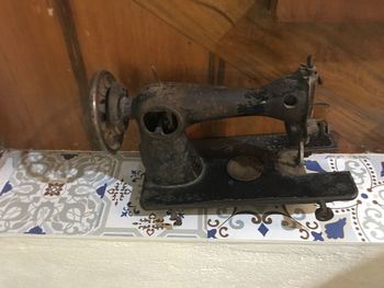 Close-up of old machine part on table