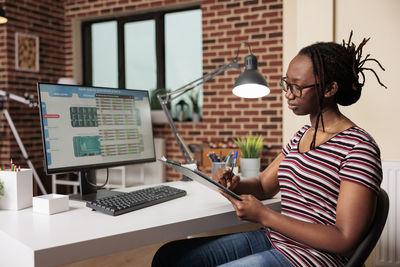 Young woman using laptop at office