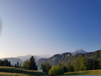 Scenic view of mountains against clear blue sky