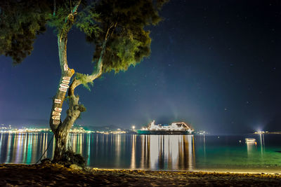 Side view of an illuminated ship in river