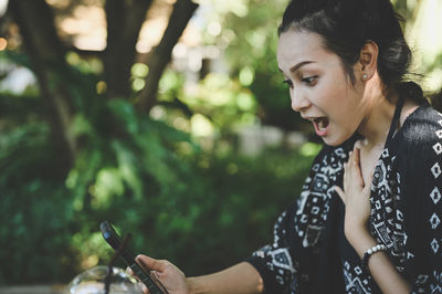 Young women surprise when her looking a mobile phone