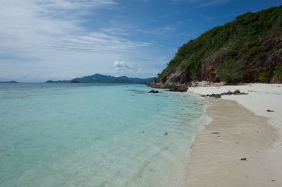 Scenic view of beach against blue sky