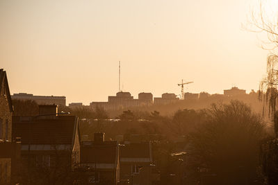 Silhouette buildings against sky during sunset