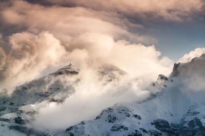 Scenic view of mountains against cloudy sky