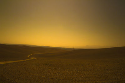 Scenic view of field against sky during sunset