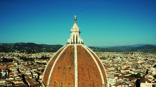 High angle view of city against clear blue sky