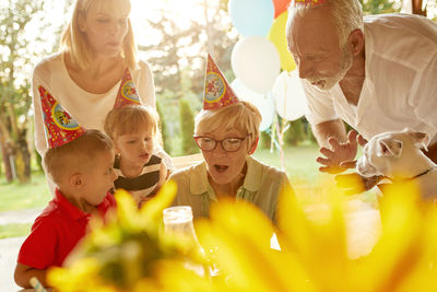 Happy extended family on a garden birthday party