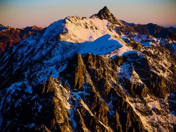 Aerial view of snowcapped mountains against sky