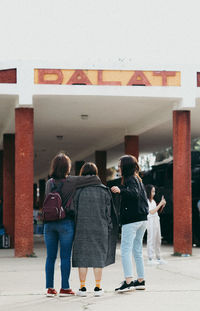 Rear view of people walking outdoors