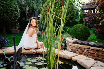 Portrait of smiling young woman sitting outdoors