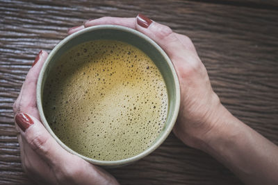 Cropped image of hand holding coffee cup