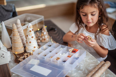 High angle view of girl holding ice cream on table