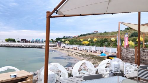 Panoramic view of restaurant and river against sky