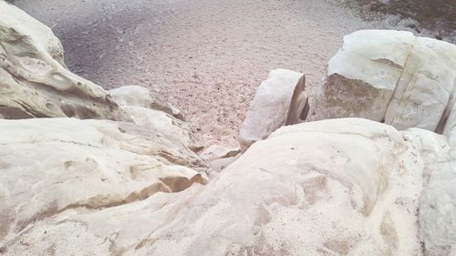 Close-up of rock on sand at beach