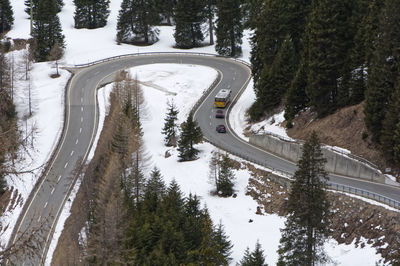High angle view of road amidst trees during winter