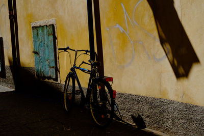 Bicycle parked against wall