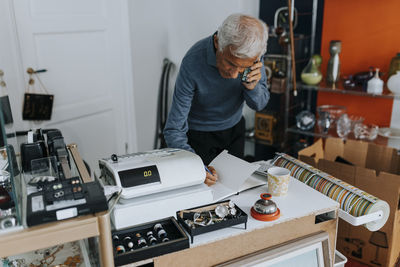 Side view of young man working at home