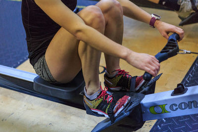 Low section of a woman exercising in gym