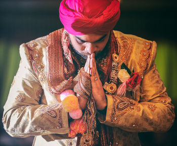 Bridegroom praying during wedding