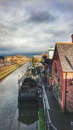 High angle view of canal amidst buildings against sky