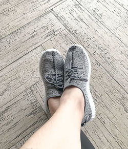 Low section of woman standing on hardwood floor