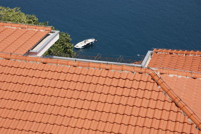 High angle view of houses by sea against sky