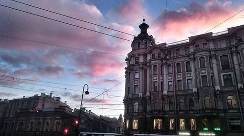 Low angle view of building against cloudy sky