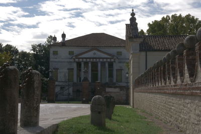 View of cemetery and building against sky